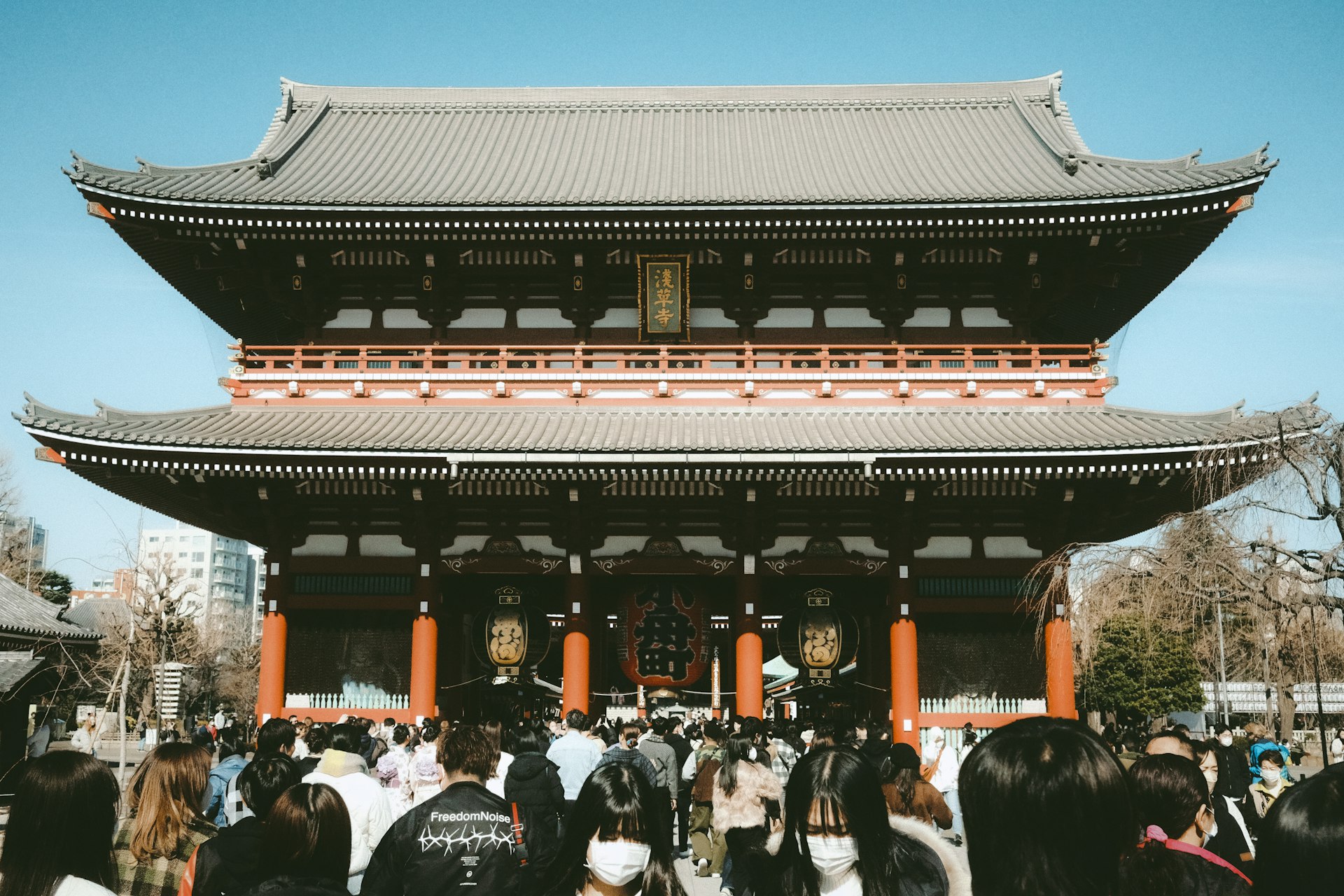 a group of people standing in front of a tall building